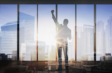 Image showing silhouette of business man over city background