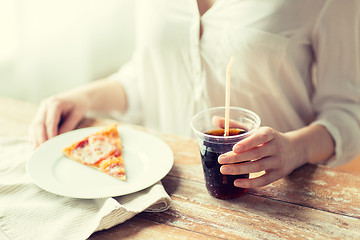 Image showing close up of woman with pizza and coca cola drink