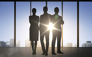 Image showing business people silhouettes over office background