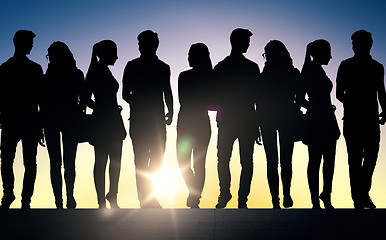 Image showing silhouettes of students on stairs over sun