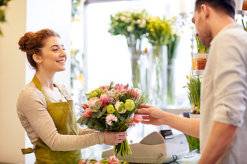 Image showing smiling florist woman and man at flower shop