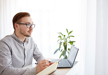 Image showing creative male worker or businessman with notebook