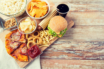 Image showing close up of fast food snacks and drink on table