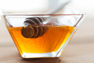 Image showing close up of honey in glass bowl and dipper