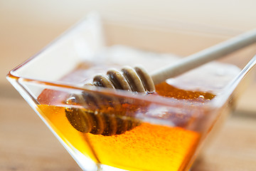 Image showing close up of honey in glass bowl and dipper