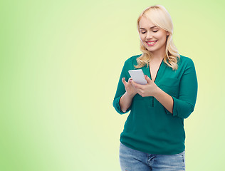 Image showing happy woman with smartphone texting message