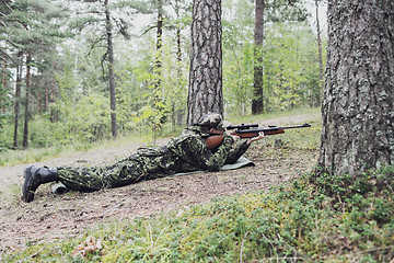 Image showing young soldier or hunter with gun in forest