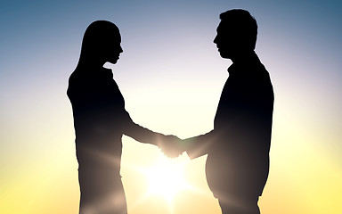 Image showing business partners silhouettes shaking hands