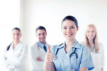 Image showing doctor with group of medics showing thumbs up