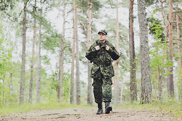 Image showing young soldier with backpack in forest