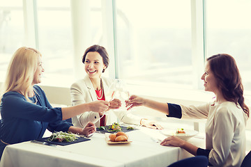 Image showing happy women drinking champagne at restaurant