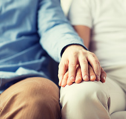 Image showing close up of happy male gay couple holding hands