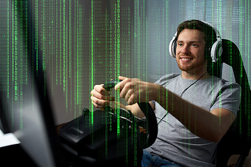 Image showing man playing car racing video game at home