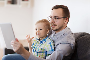 Image showing father and son with tablet pc playing at home