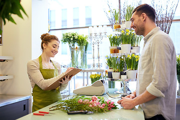 Image showing florist woman and man making order at flower shop
