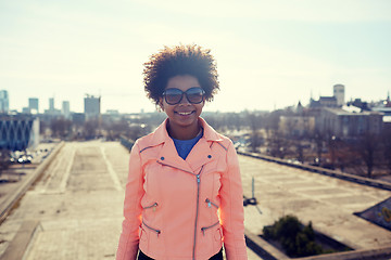 Image showing happy african american woman in shades on street