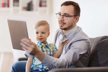 Image showing father and son with tablet pc playing at home