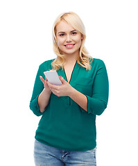 Image showing happy woman with smartphone texting message