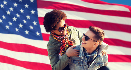 Image showing happy multiracial couple over american flag