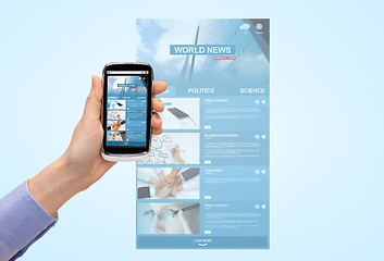 Image showing close up of hand with news web page on smartphone