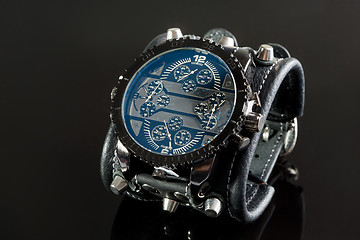 Image showing close-up of wristwatch on a black background