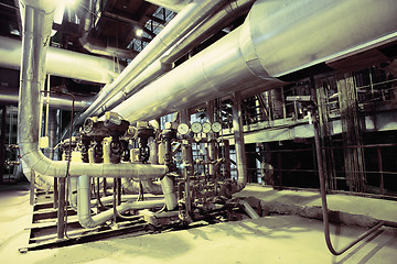 Image showing Equipment, cables and piping as found inside of a modern industr