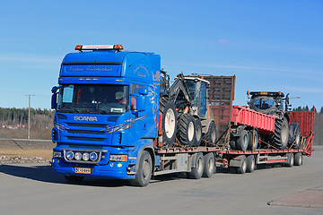 Image showing Blue Scania Truck Hauls Agricultural Equipment