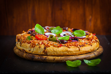 Image showing Traditional homemade pizza with tomatoes and olives