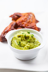 Image showing Grilled chicken wings with guacamole