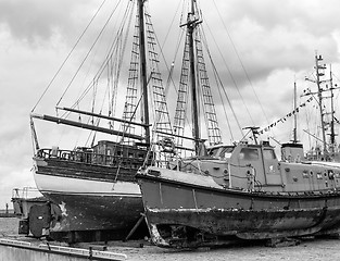 Image showing Old collapsing sailboats at the dock, close-up