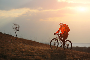 Image showing Man cyclist with backpack riding the bicycle