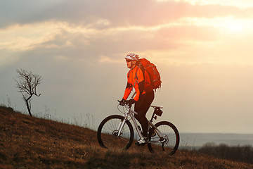 Image showing Man cyclist with backpack riding the bicycle