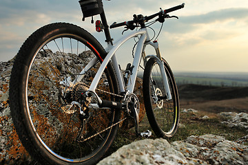 Image showing Bicycle stands on a rock