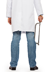 Image showing Crazy doctor is holding a big saw in his hands