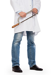 Image showing Crazy doctor is holding a big saw in his hands