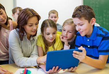 Image showing group of kids with teacher and tablet pc at school