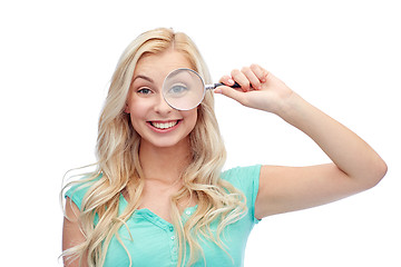 Image showing happy young woman with magnifying glass