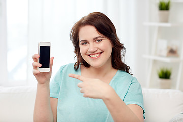Image showing happy plus size woman with smartphone at home