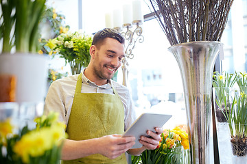 Image showing man with tablet pc computer at flower shop