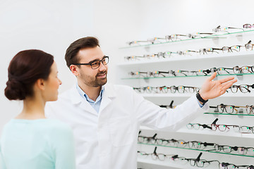 Image showing woman and optician showing glasses at optics store