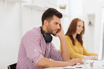 Image showing creative team with headphones and computer