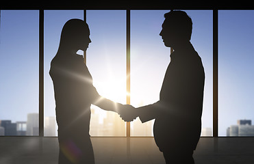 Image showing business partners silhouettes shaking hands