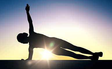 Image showing woman doing plank exercise on stairs over sunlight