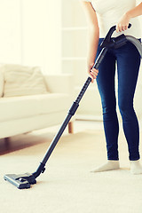 Image showing close up of woman with vacuum cleaner at home