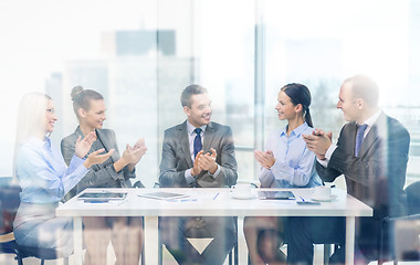 Image showing business team with laptop clapping hands