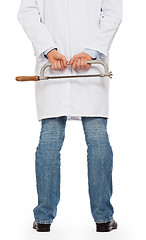 Image showing Crazy doctor is holding a big saw in his hands