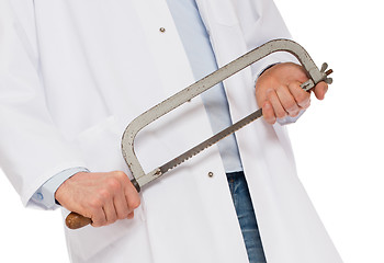 Image showing Crazy doctor is holding a big saw in his hands