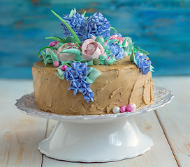 Image showing Festive coffee cake with flowers of cream.