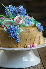 Image showing Coffee cake with flowers of cream.