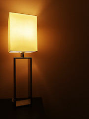 Image showing Illuminated table lamp in a dark room